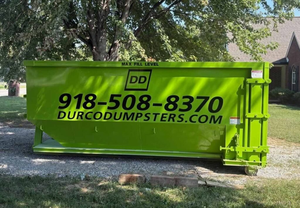 A photo of a green dumpster, one of several dumpster sizes available from Durco dumpsters.