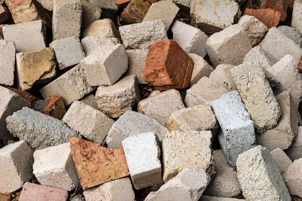 Pile of broken concrete and brick, heavy debris that fills a dumpster by weight