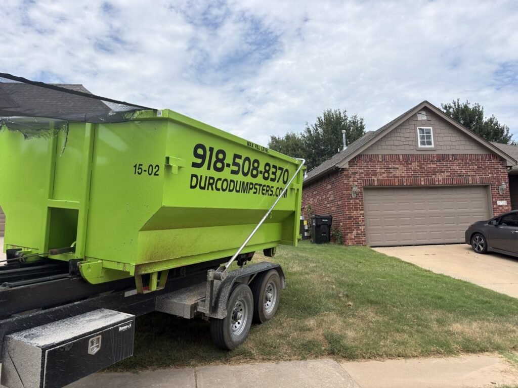 Durco roll-off dumpster on a trailer at a brick home in the Tulsa metro